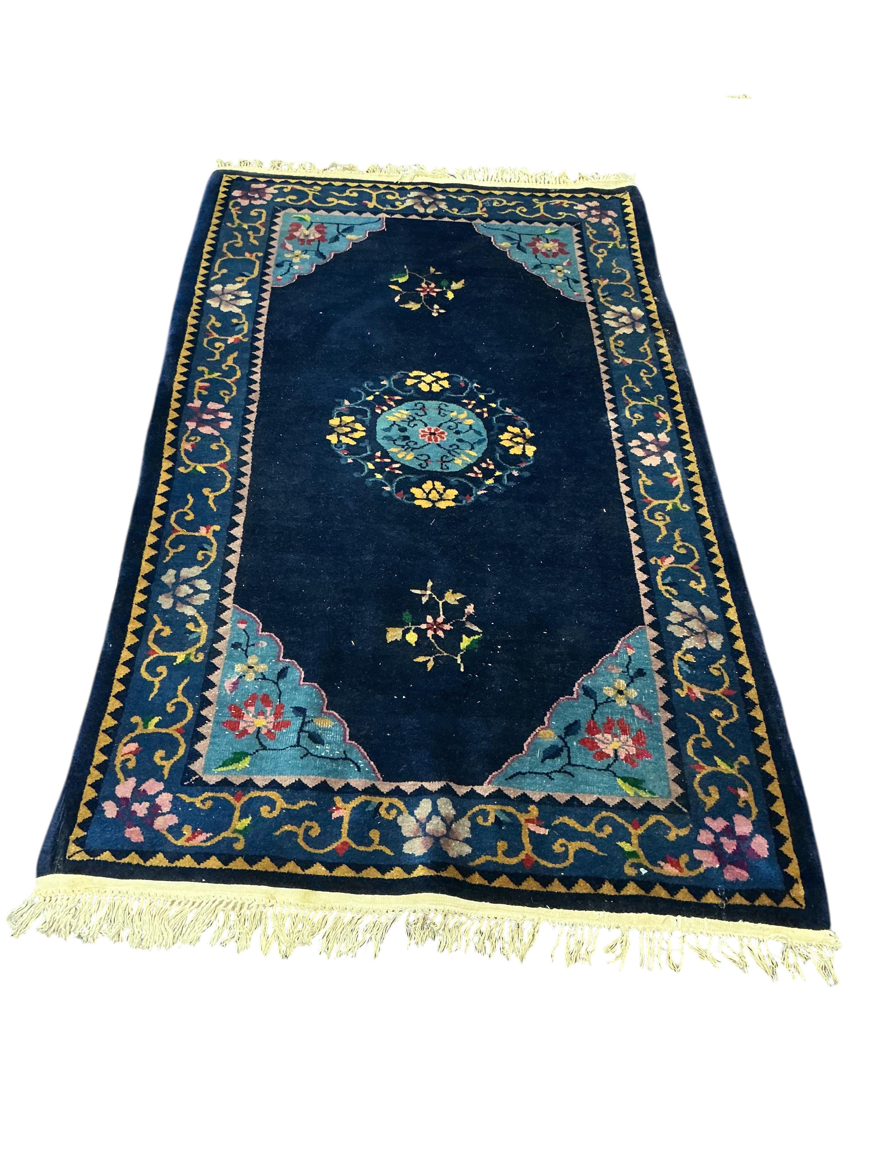 A Chinese blue ground rug, 210 x 120cm
